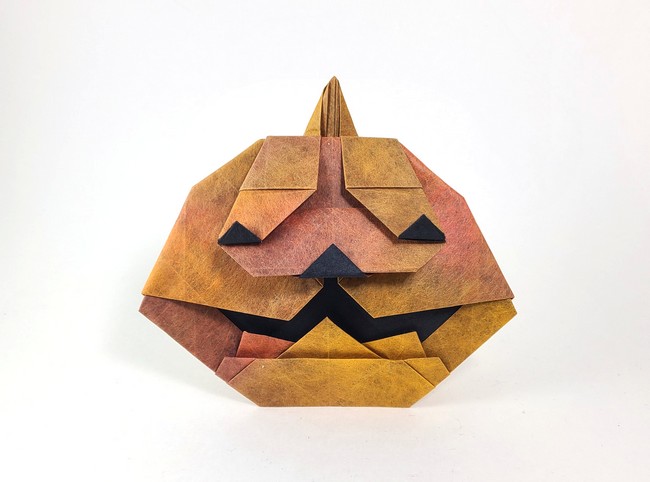 Origami Jack-o'-lantern by Wei Lin Chen. Folded from a square of Shadow Thai origami paper by Gilad Aharoni on giladorigami.com