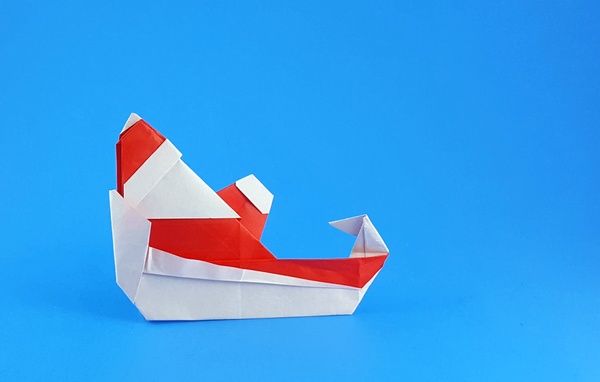 Origami Santa Claus in sleigh by Francesco Miglionico. Folded from a square of origami paper by Gilad Aharoni on giladorigami.com