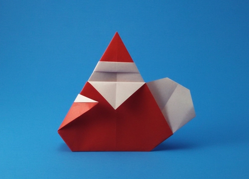 Origami Santa Claus with bag by Umemoto Yoshihiro. Folded from a square of origami paper by Gilad Aharoni on giladorigami.com